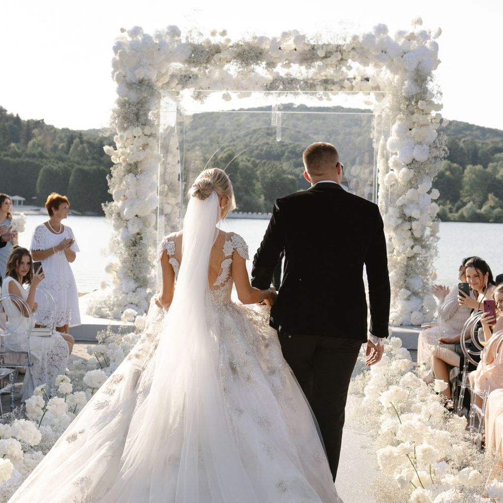 groom-walks-down-the-aisle-with-bride.