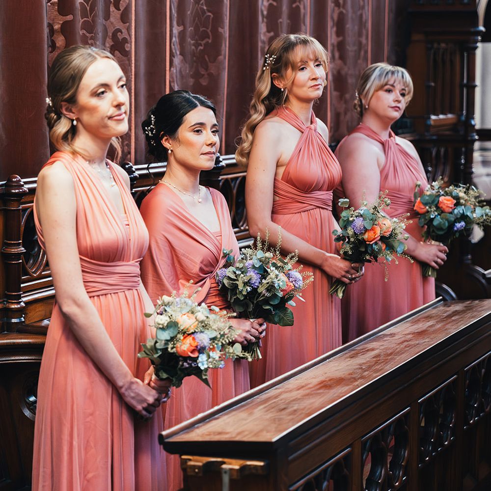bridal-party-wearing-coral-pink-bridesmaid-dresses