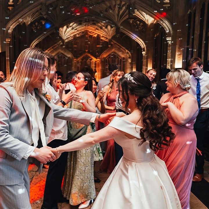 bride dances-with-wedding-guest-at-reception