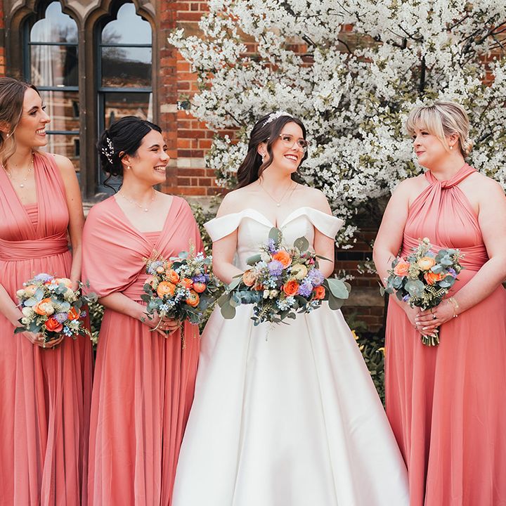 coral-pink-bridesmaid-dresses-with-bride-in-off-the-shoulder-wedding-dress