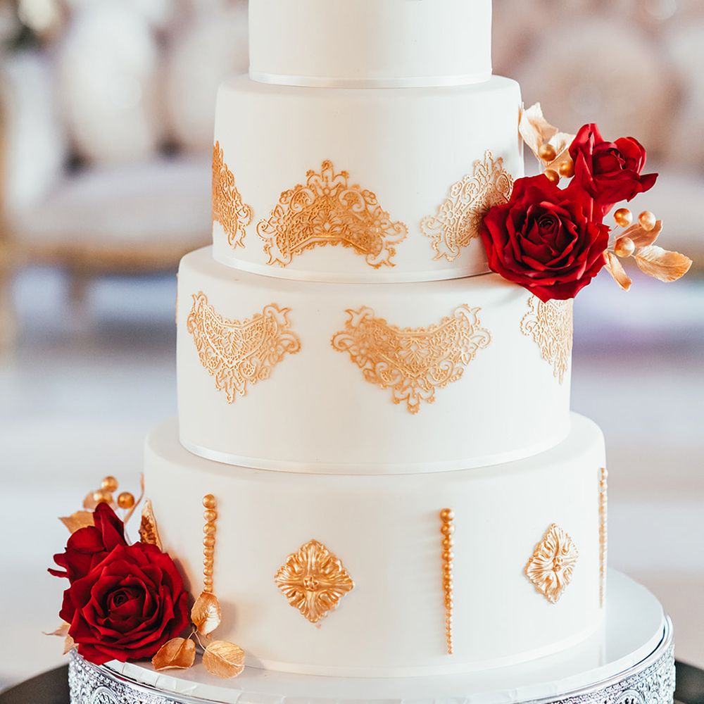 four-tier-white-iced-cske-with-gold-foil