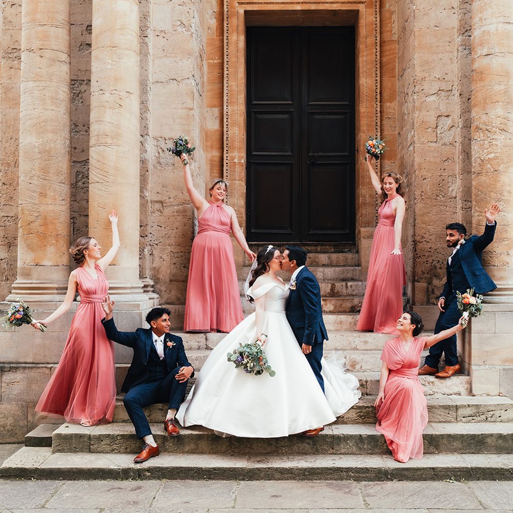 navy-suits-coral-bridesmaid-dresses-at-classic-wedding