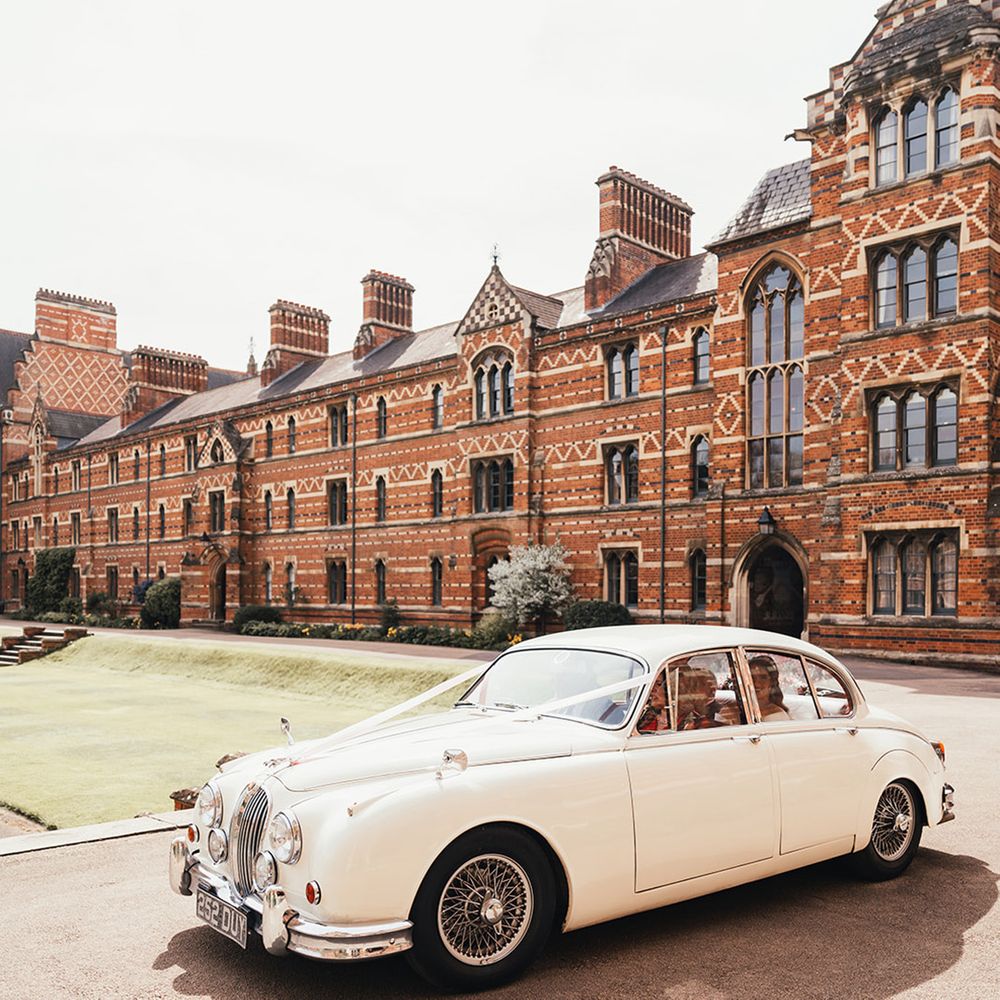 white-vintage-sports-wedding-car-with-ribbon