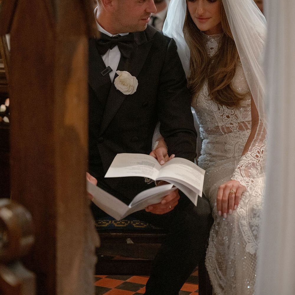 bride-and-groom-reading-hymns-from-order-of-service