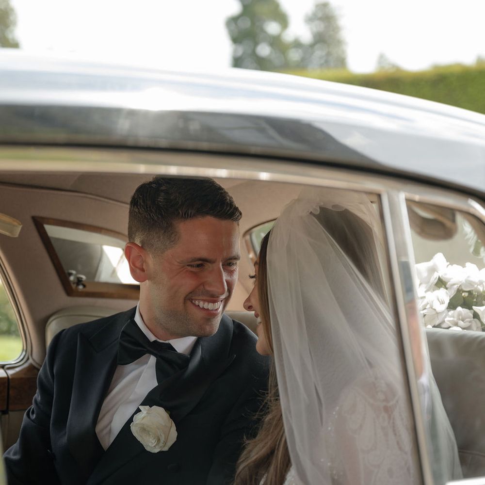 bride-and-groom-smiling-in-luxe-vintage-car