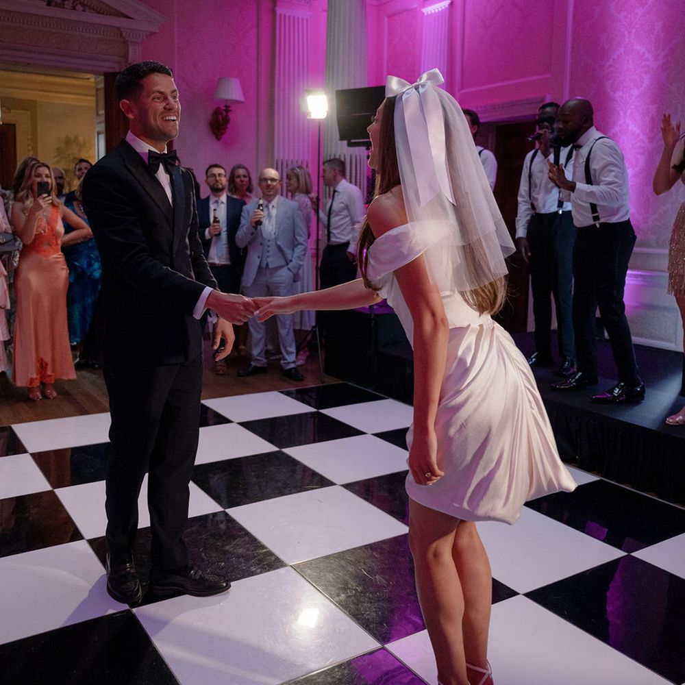 bride-in-short-vivienne-westwood-dress-dancing-with-groom