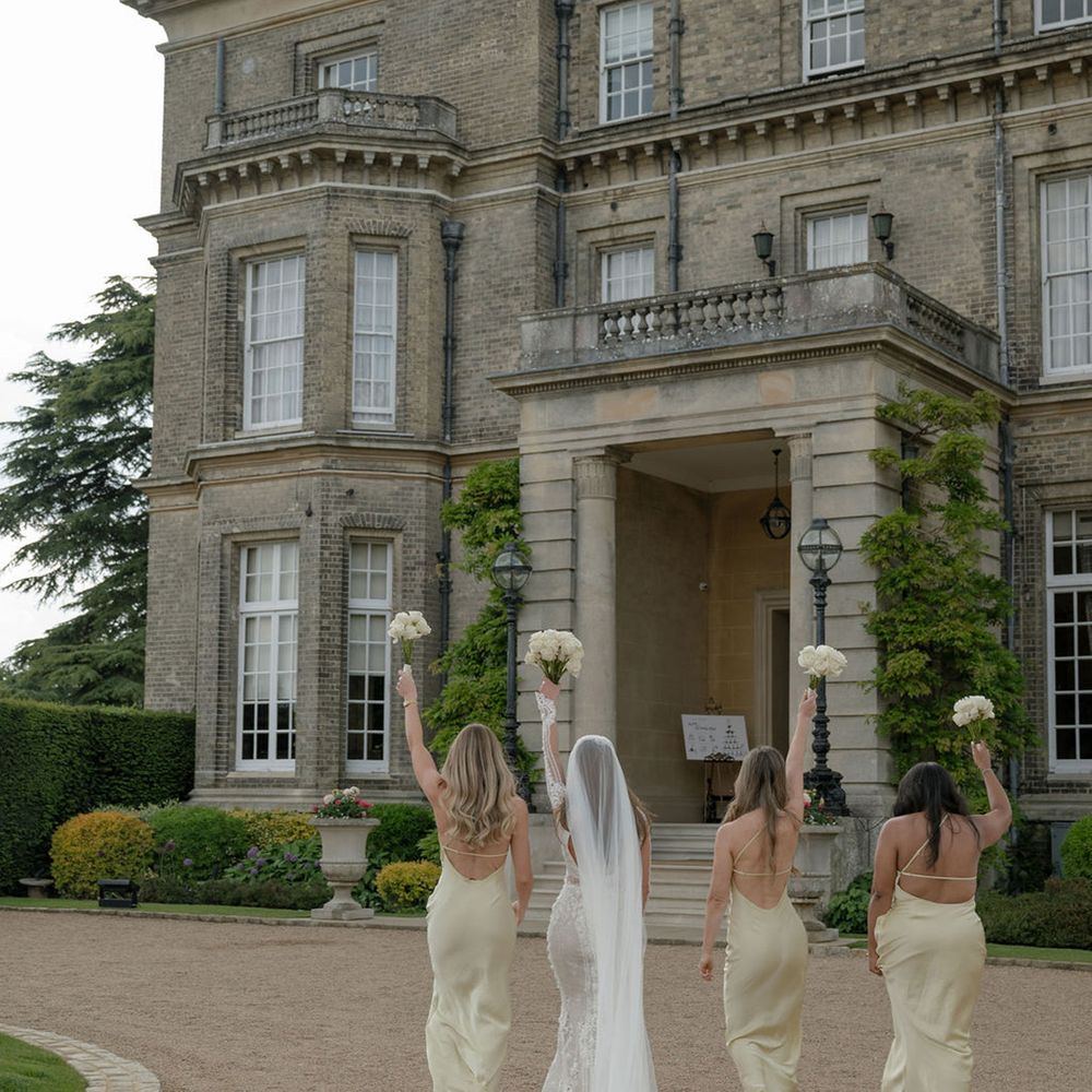 Bridesmaids in butter yellow bridesmaid dresses with bride