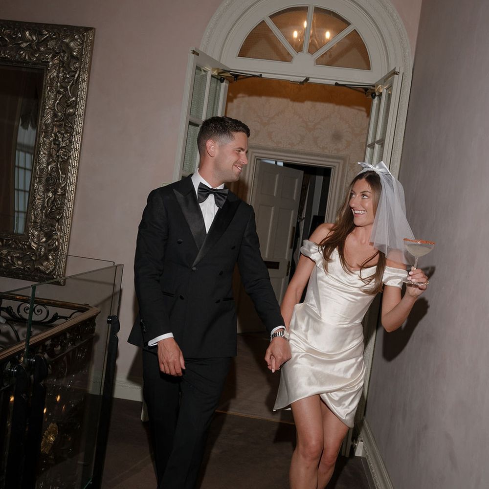 Groom in black tux and bride in short wedding dress