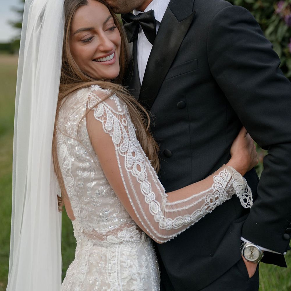 Groom kisses bride on the forehead