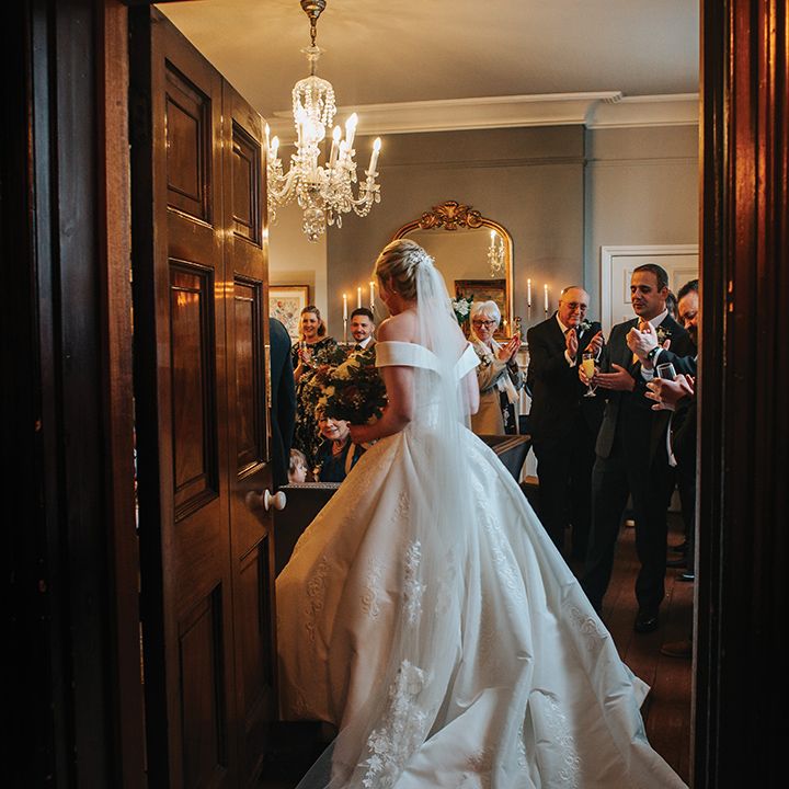 bride-in-off-the-shoulder-wedding-dress-making-entrance