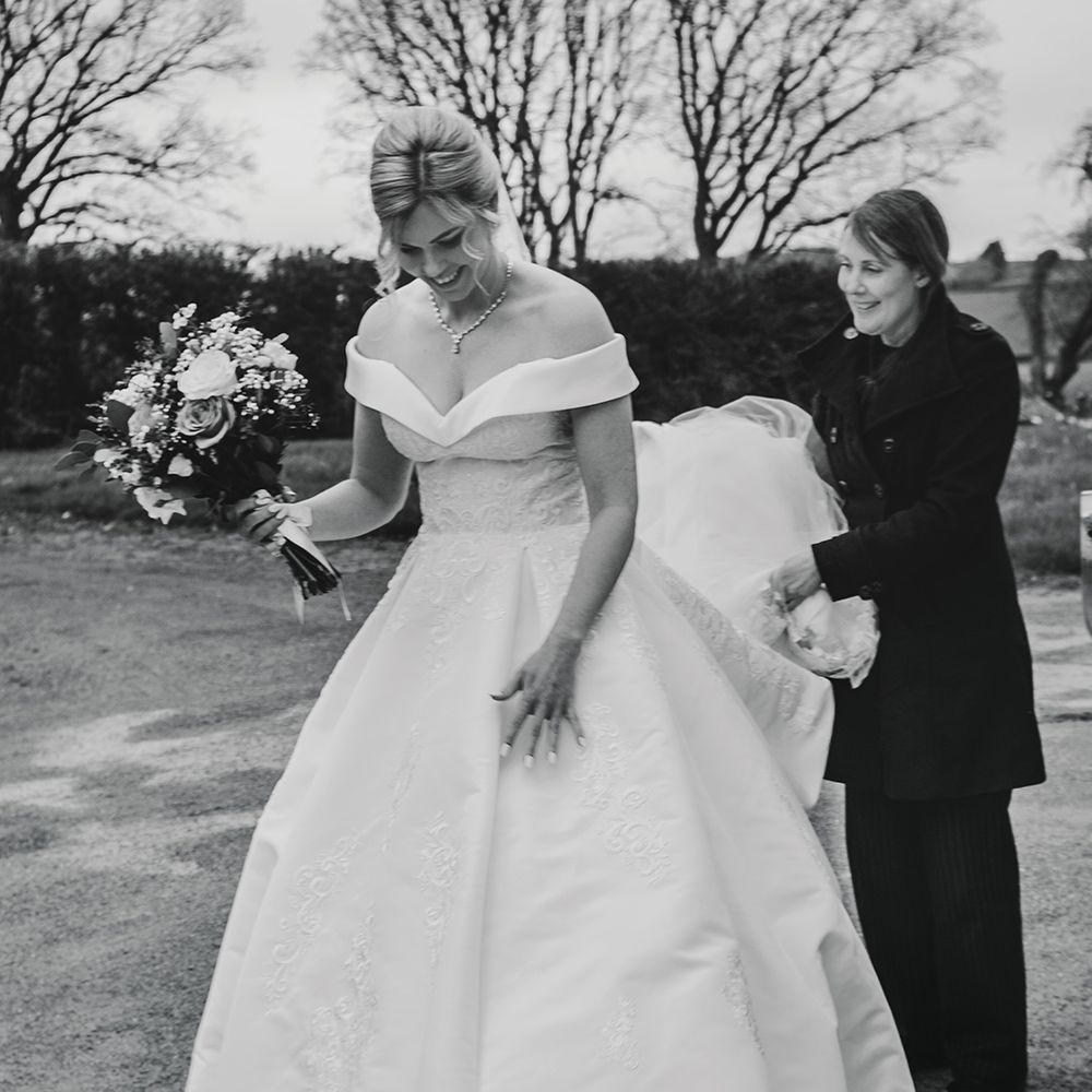bride-in-off-the-shoulder-wedding-dress-walking-to-church
