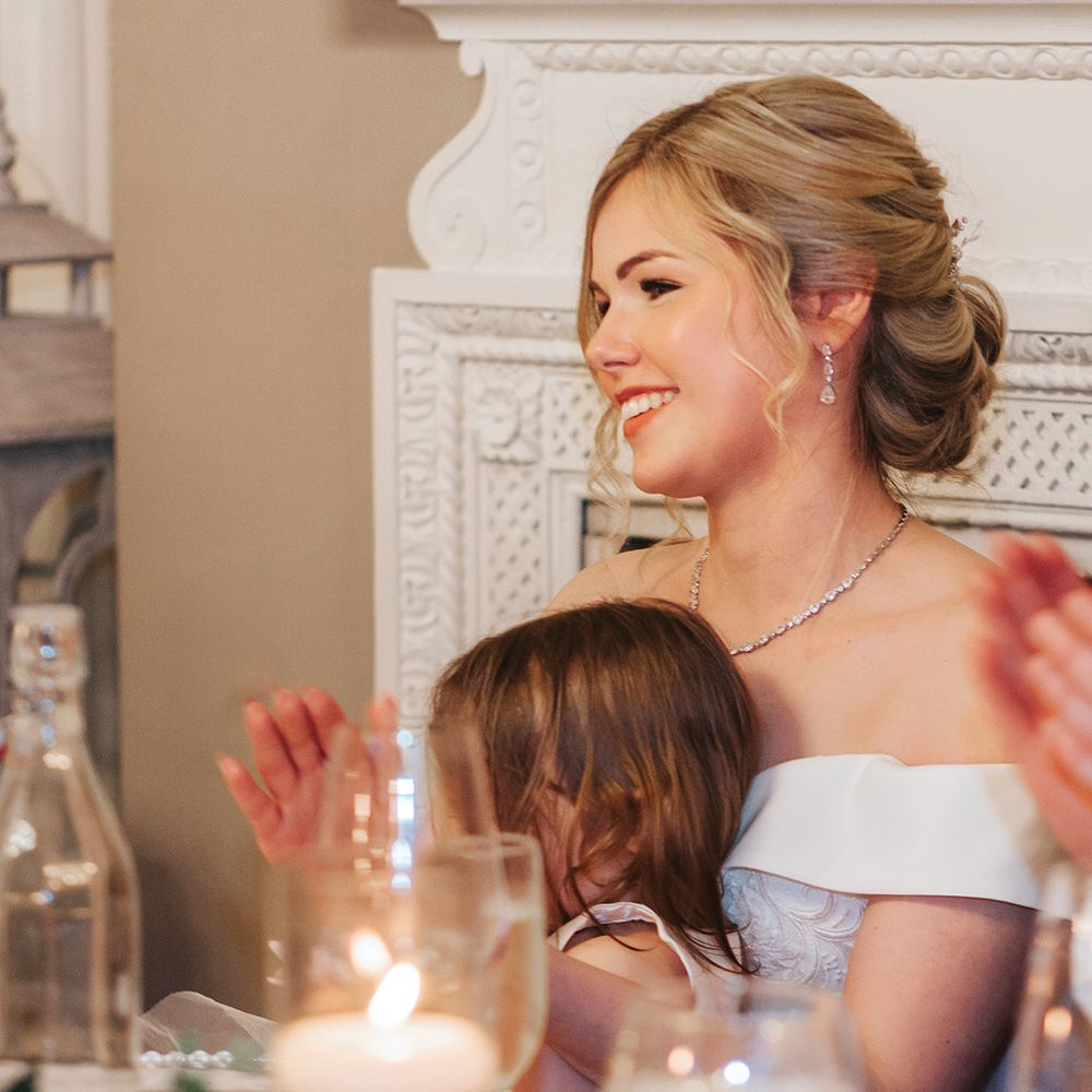 bride-smiles-during-the-wedding-speeches