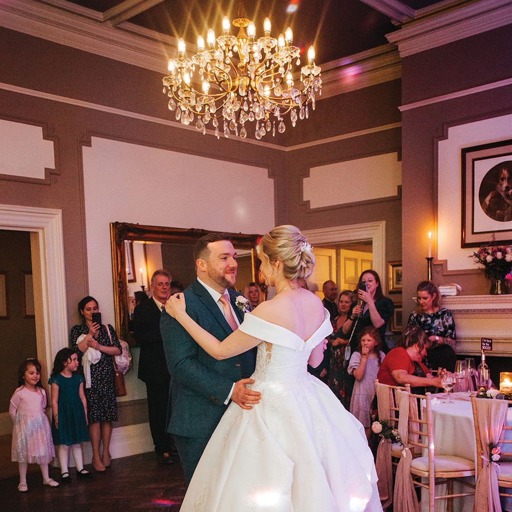 groom-dances-with-bride-on-dance-floor-at-country-house-wedding