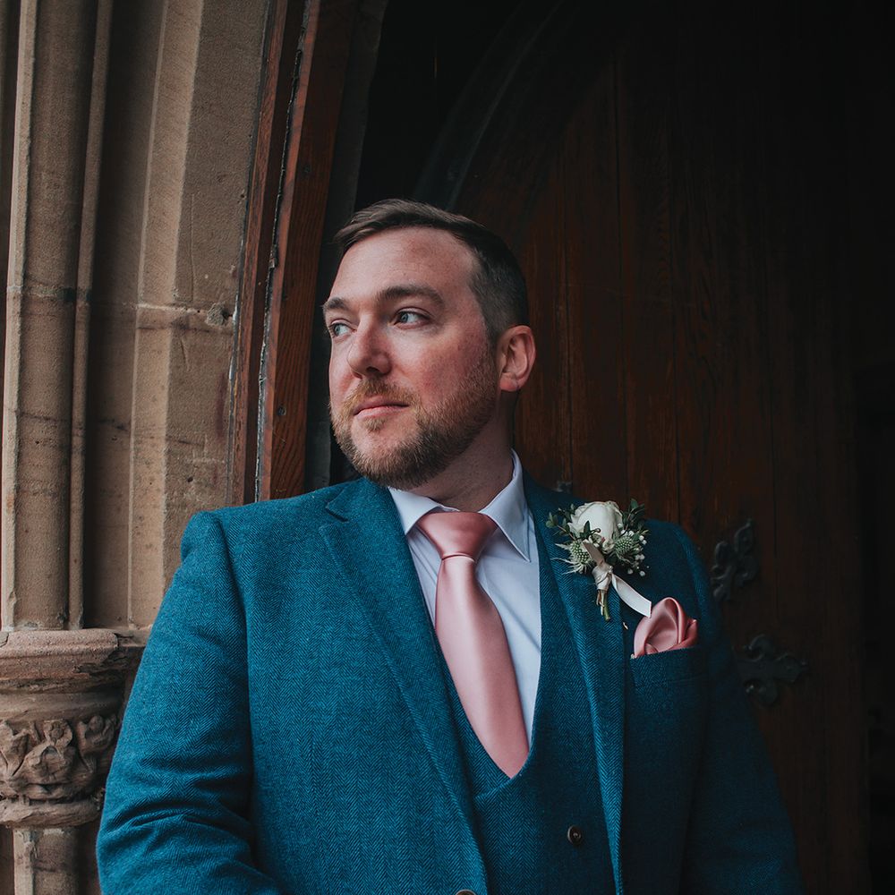 groom-in-blue-wedding-suit-with-pink-tie