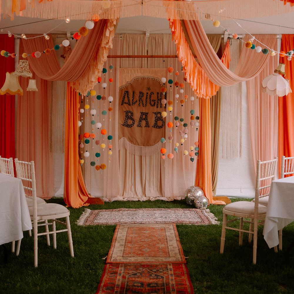 colourful-orange-red-yellow-streamers-with-pom-pom-garland-and-diy-sign-decor