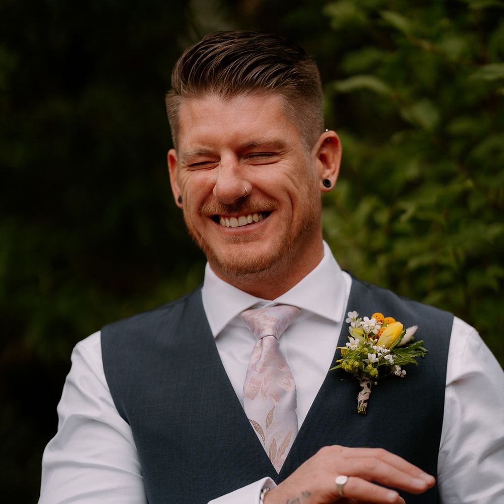 groom-putting-on-cufflinks-winking