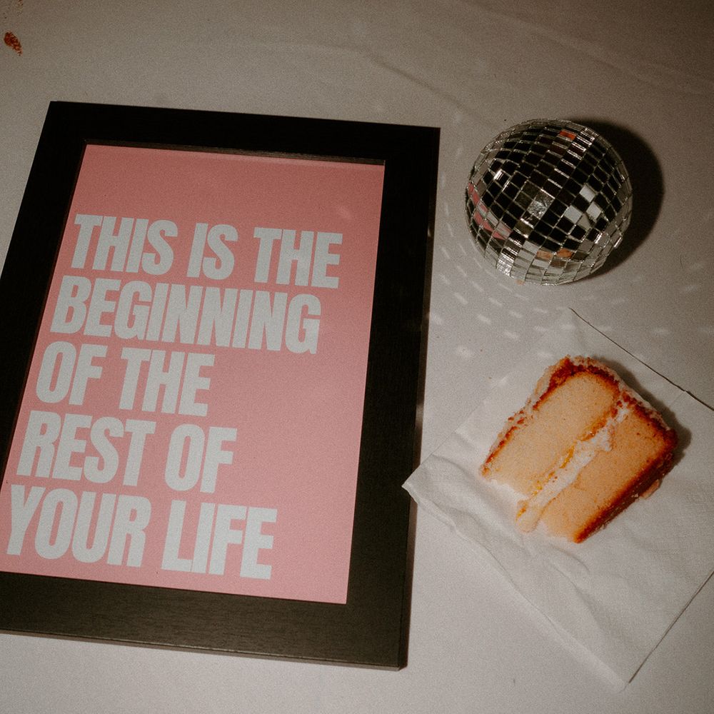 slice-of-wedding-cake-with-mini-disco-ball-and-signage