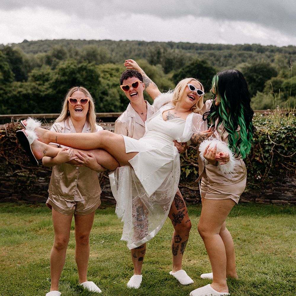 bridal-party-in-gold-robes-lift-bride