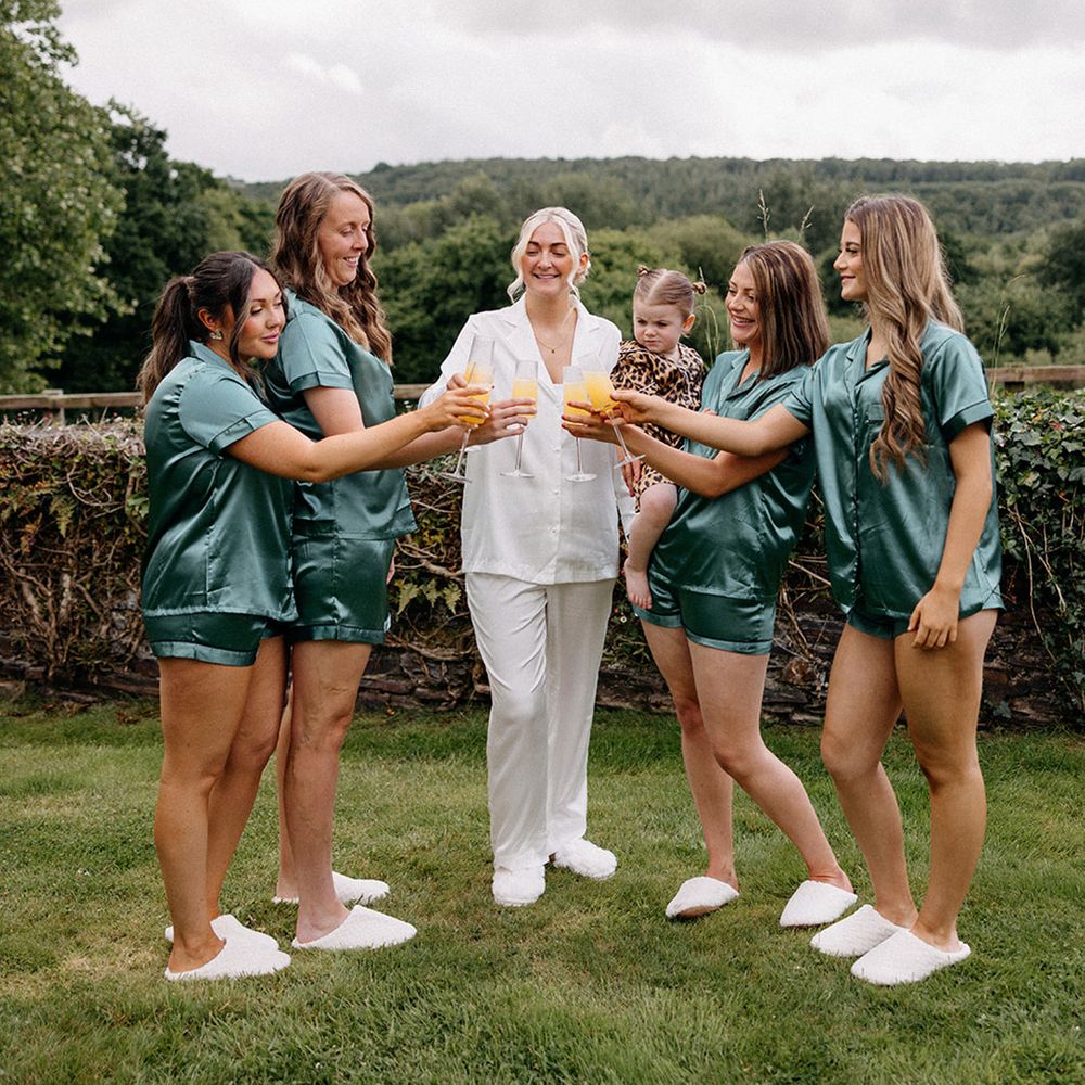 bridal-party-in-green-satin-pyjamas-cheers-together