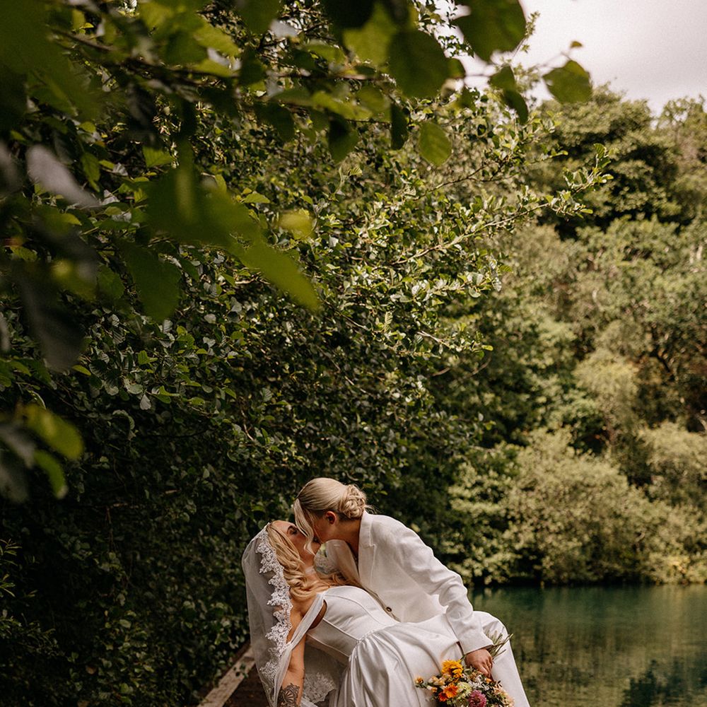 bride-in-wedding-suit-kisses-bride-in-drop-waist-wedding-dress