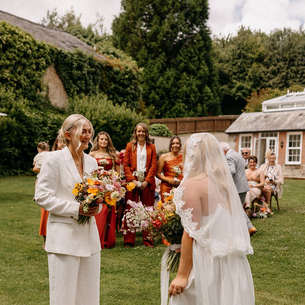brides-stand-at-outdoor-wedding-ceremony-wooladon-estate