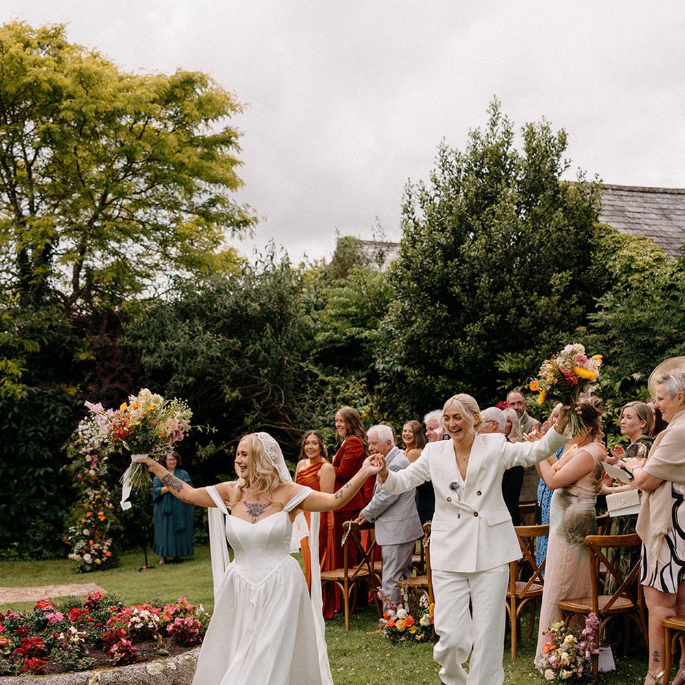 brides-walk-down-the-aisle-together-as-married-couple