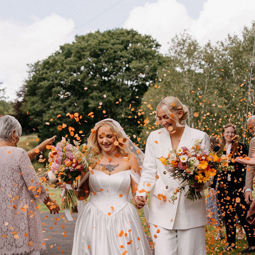 orange-confetti-moment-for-two-brides