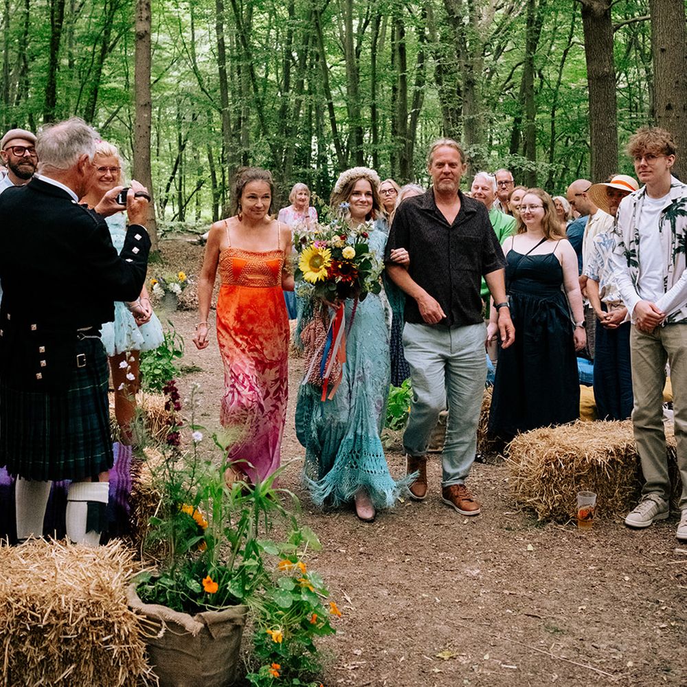 bride-in-blue-wedding-dress-walking-down-the-aisle-with-parents