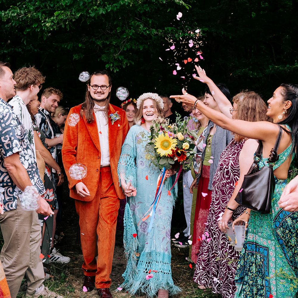 confetti-moment-for-bride-and-groom-in-colourful-alternative-wedding-outfits