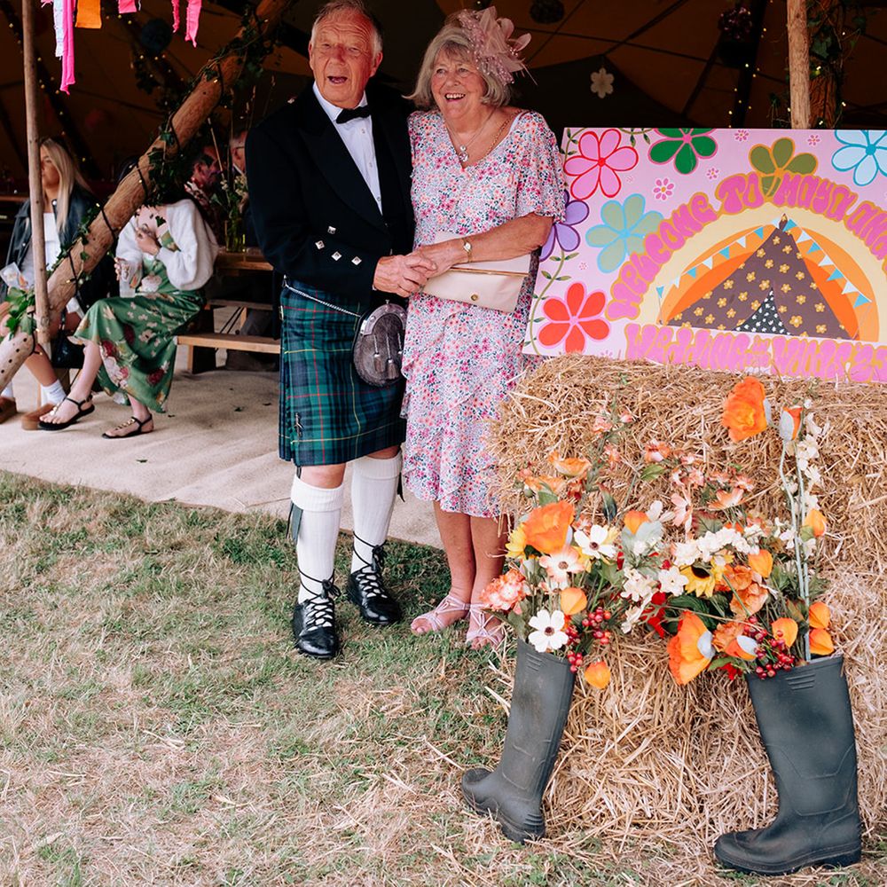 mother-father-of-the-bride-under-colourful-diy-streamers