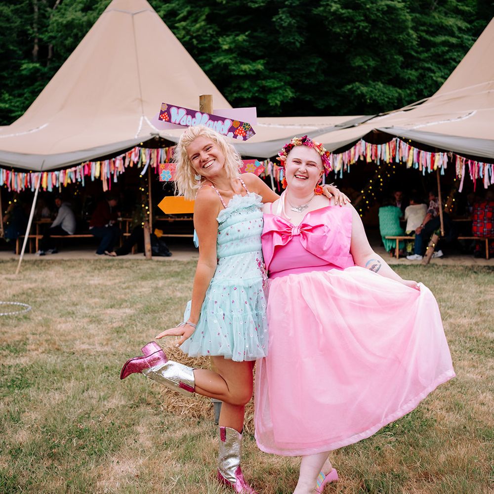 wedding-guests-pose-in-front-of-tipi