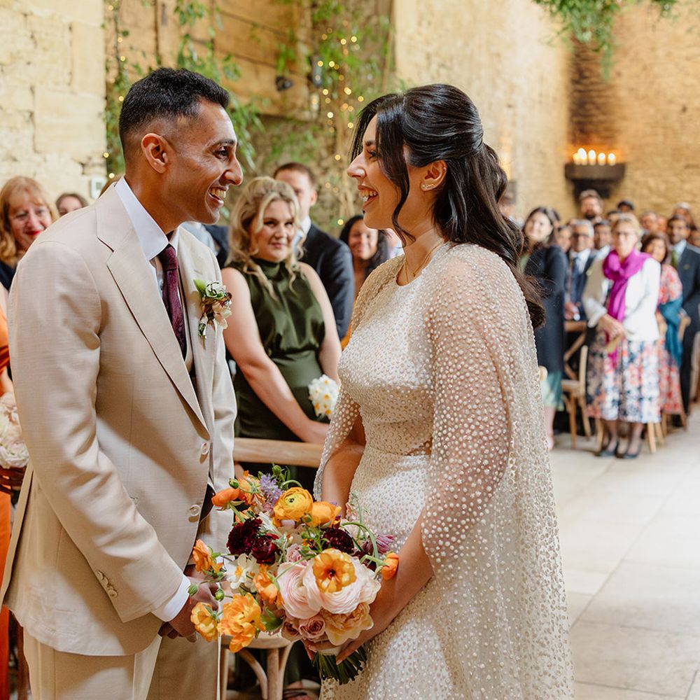 barn-wedding-ceremony-with-bride-and-groom-smiling