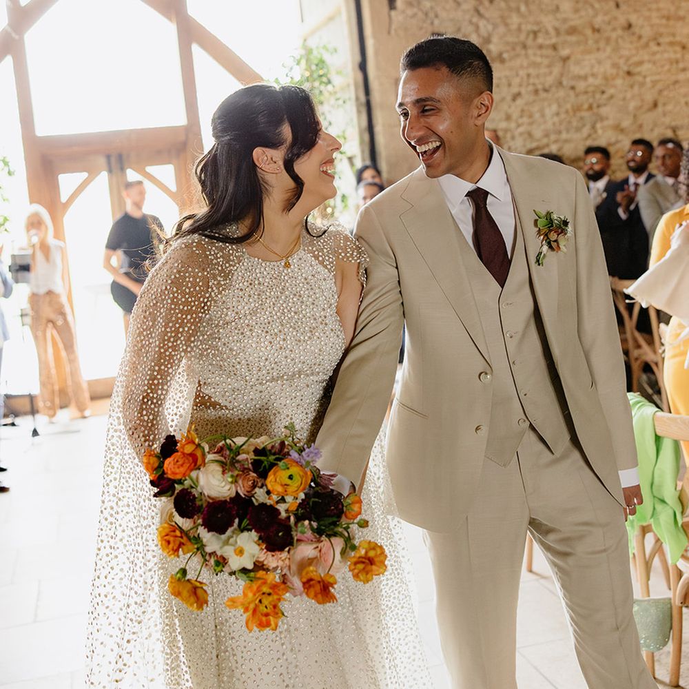 jesus-piero-wedding-dress-and-cream-suit-walking-back-down-the-aisle-as-married-couple