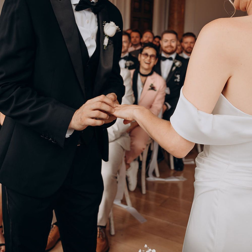 groom-places-ring-on-brides-finger