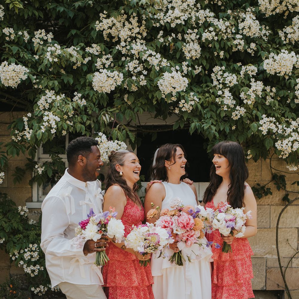bridal-party-group-photo-with-red-ruffle-bridesmaid-dresses-and-bridesman-in-bow-shirt
