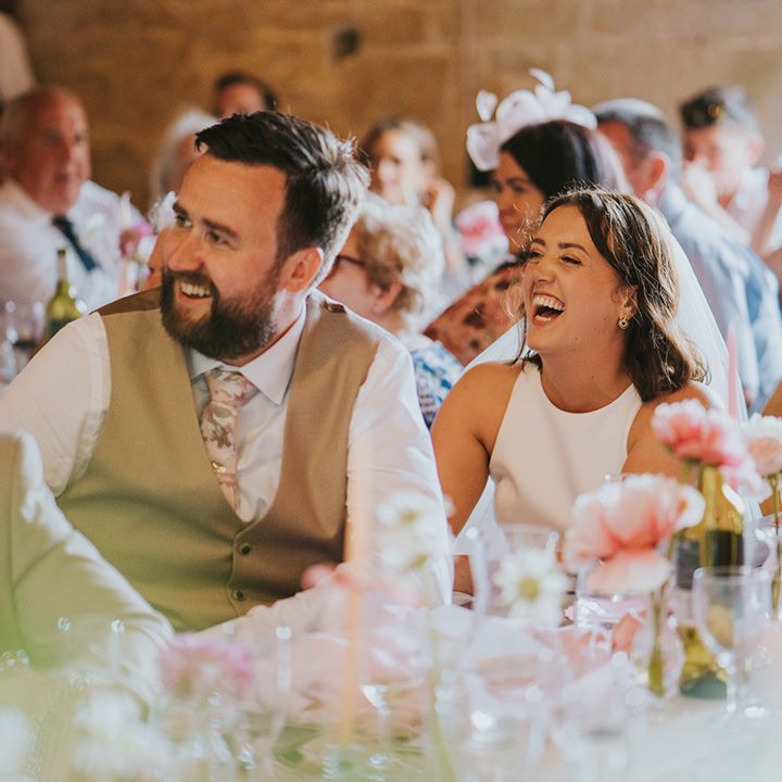 bride-and-groom-laugh-during-speeches