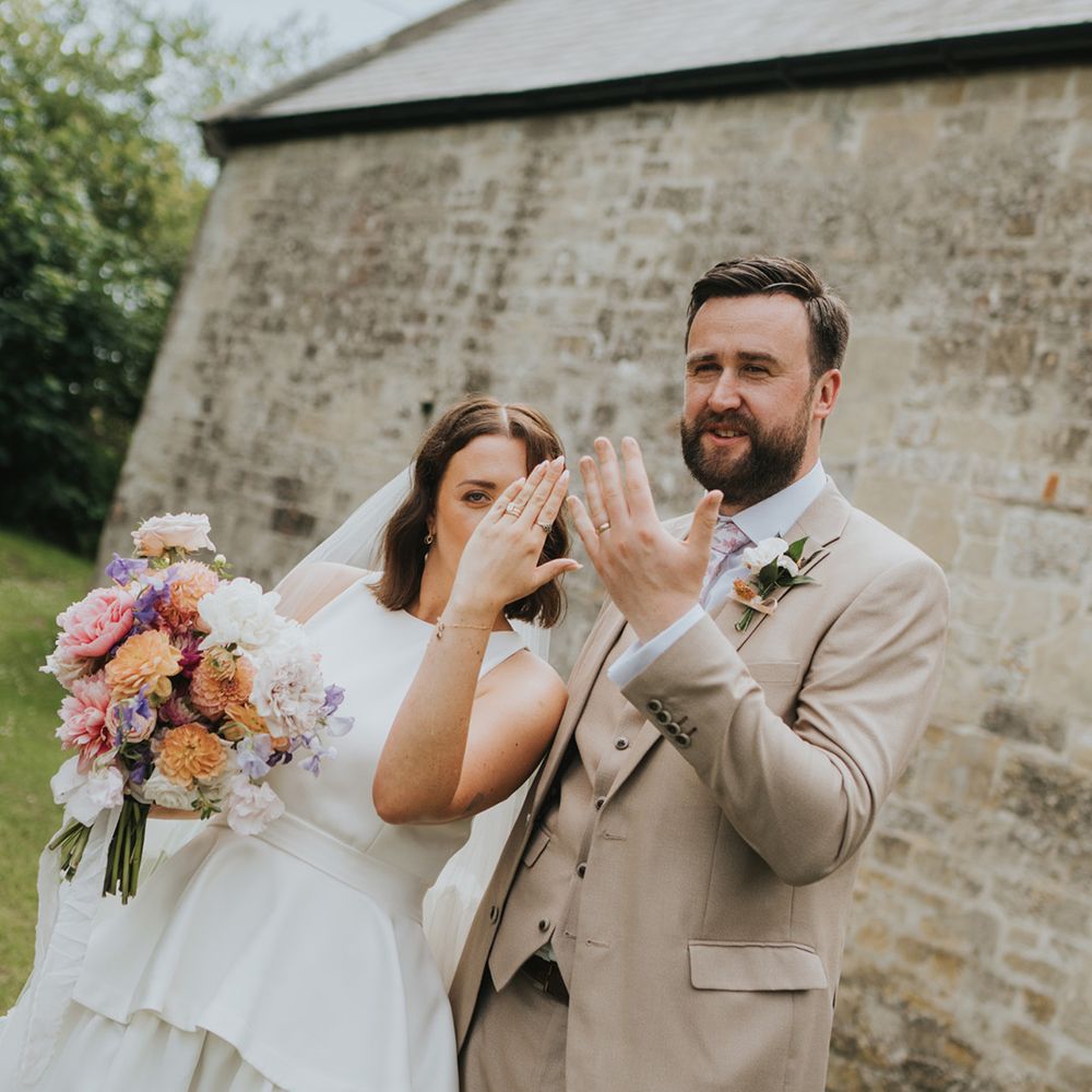 bride-and-groom-showing-their-new-wedding-rings
