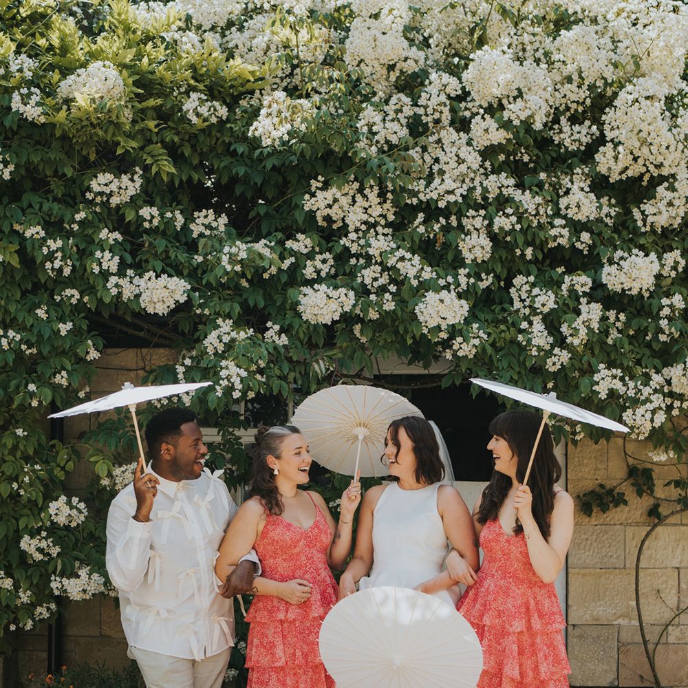 bridesmaids-in-red-ruffle-bridesmaid-dresses-and-bridesman-in-pink-bow-shirt