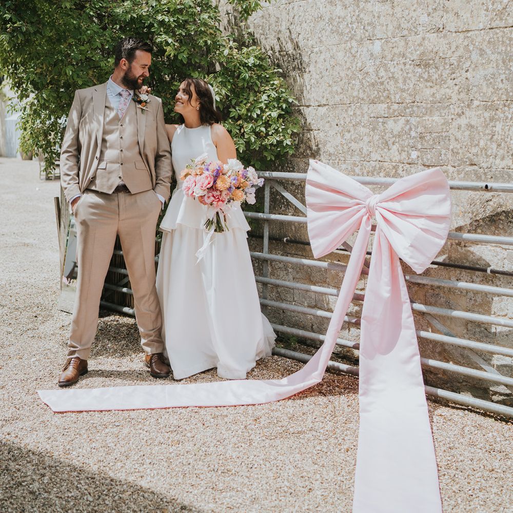 large-pink-bow-decoration-on-farm-gate-for-farm-wedding