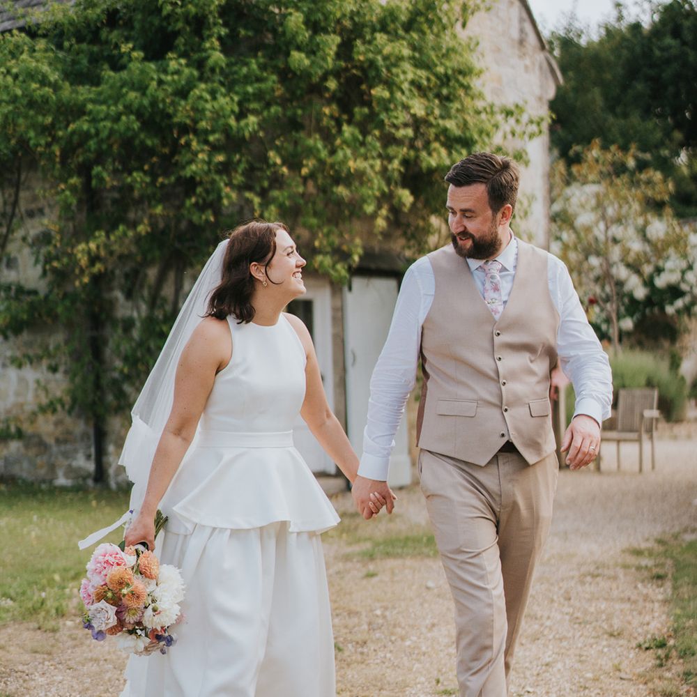 light-beige-waistcoat-and-trousers-walking-with-bride-in-peplum-dress