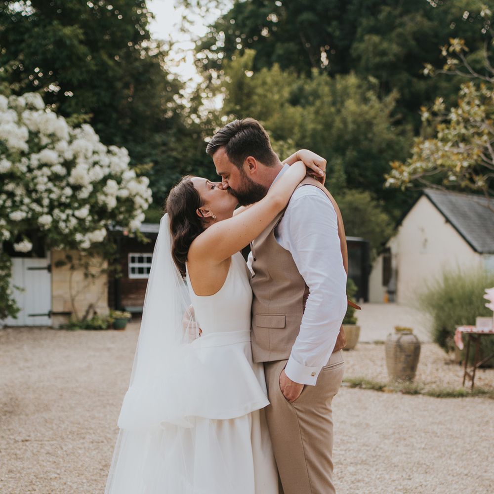 rustic-farm-wedding-with-bride-leaning-up-for-a-kiss