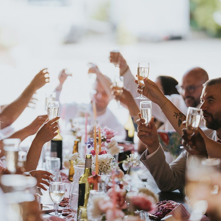 wedding-guests-cheers-at-wedding-breakfast