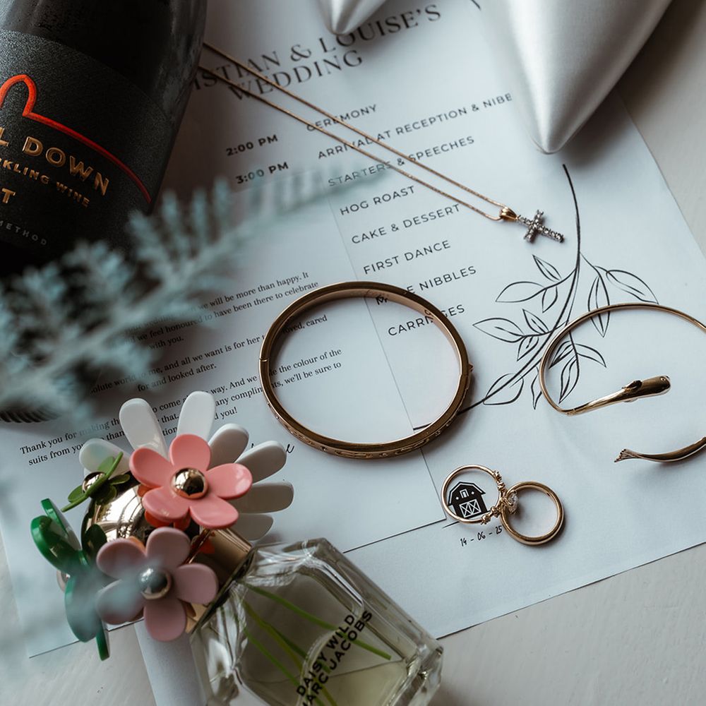 bridal-jewellery-shoes-and-perfume-with-wedding-champagne-and-invitation