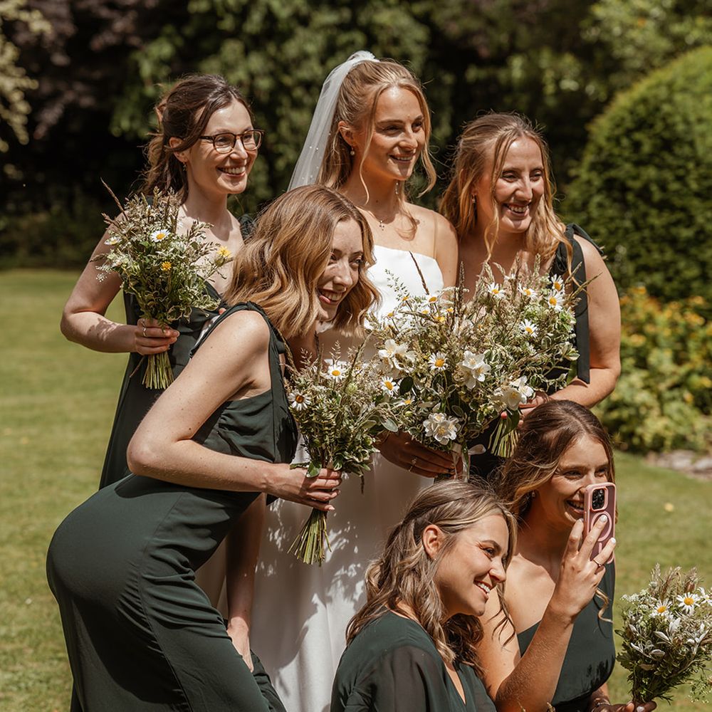 bridal-party-wearing-dark-green-bridesmaid-dresses