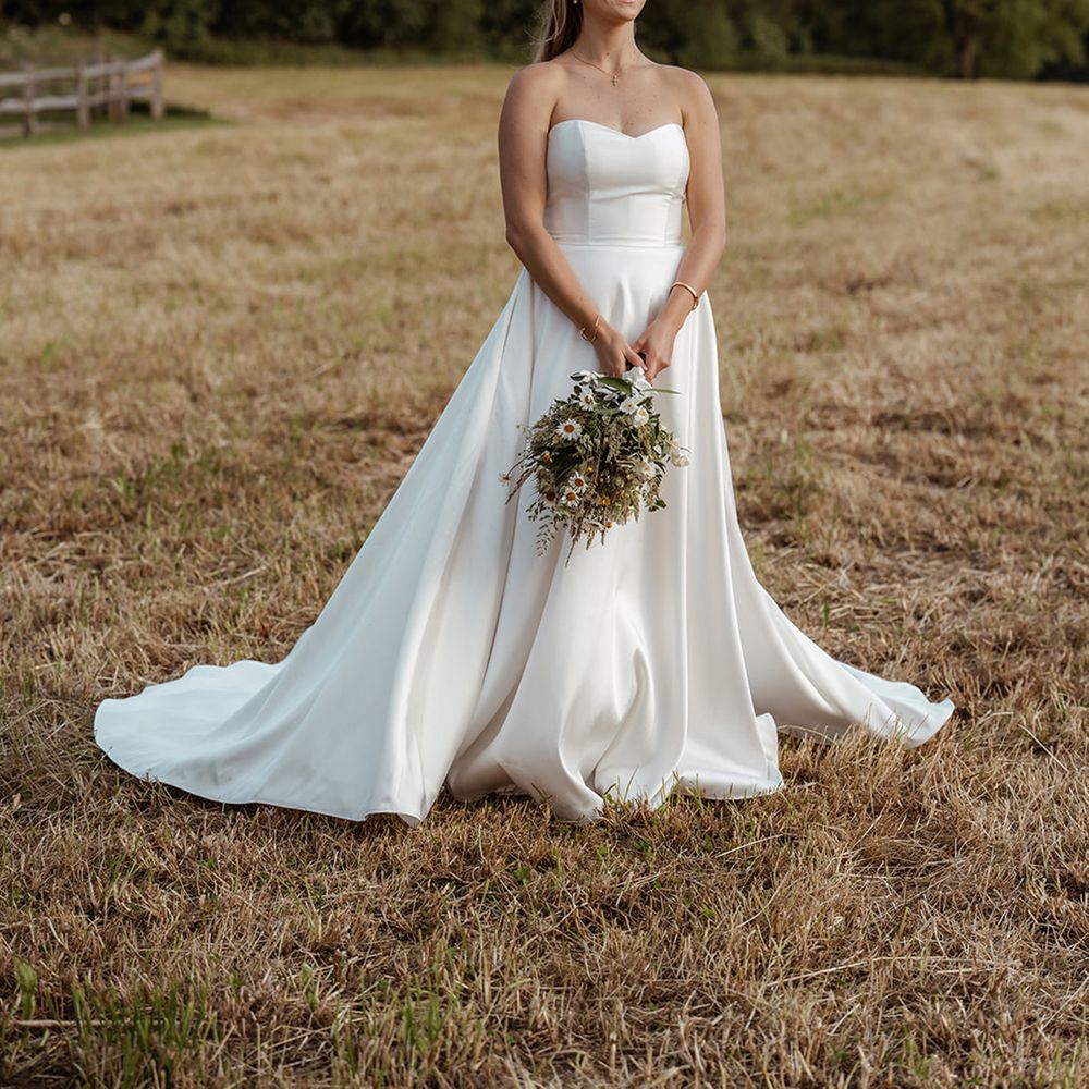 bride-in-strapless-wedding-dress-with-wildflower-bouquet