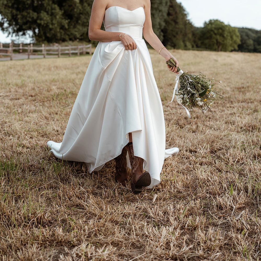 bride-wears-brown-leather-cowboy-boots-with-wedding-dress