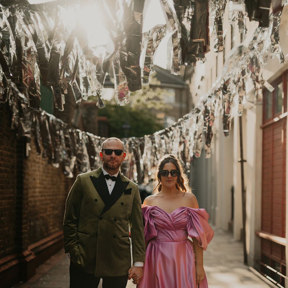bride-in-pink-wedding-dress-with-groom-ind-dark-velvet-tuxedo