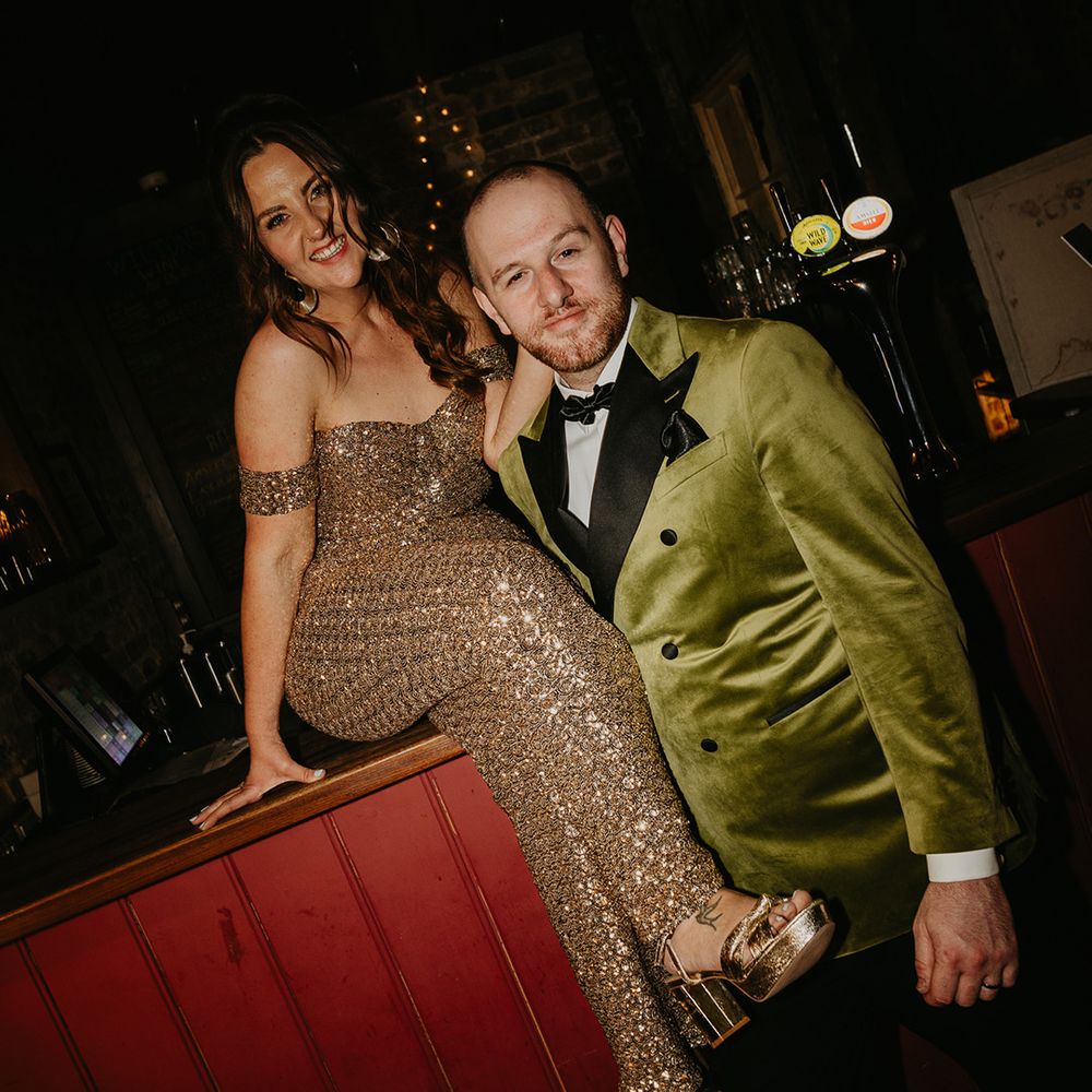 bride-in-sparkly-jumpsuit-wedding-reception-outfit-with-groom