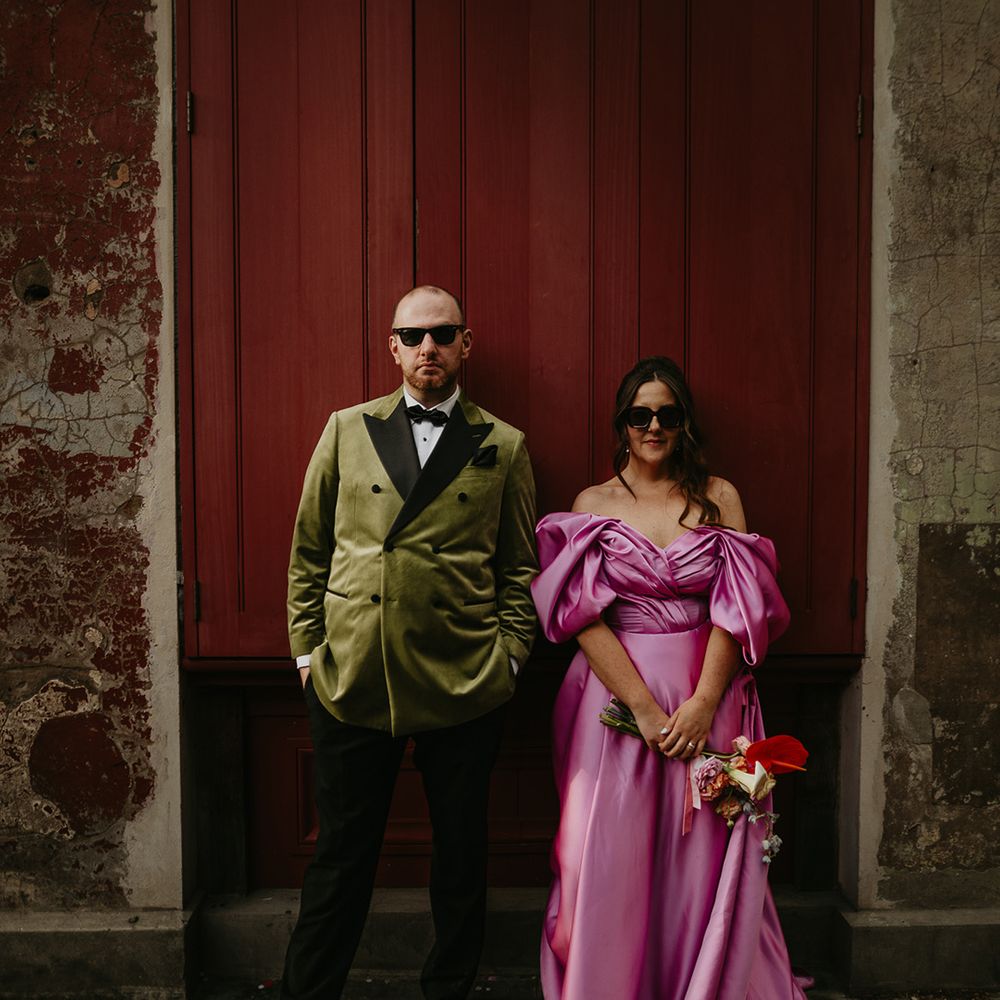 colourful-pink-wedding-dress-with-groom-in-dark-green-velvet-tuxedo