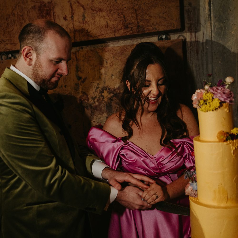 couple-cuts-yellow-wedding-cake